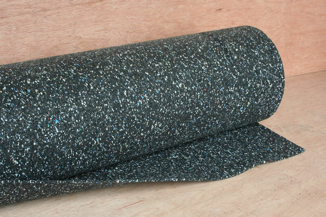 Roll of dark speckled acoustic rubber mat used in ceiling soundproofing to decouple plasterboard and reduce impact and airborne noise.