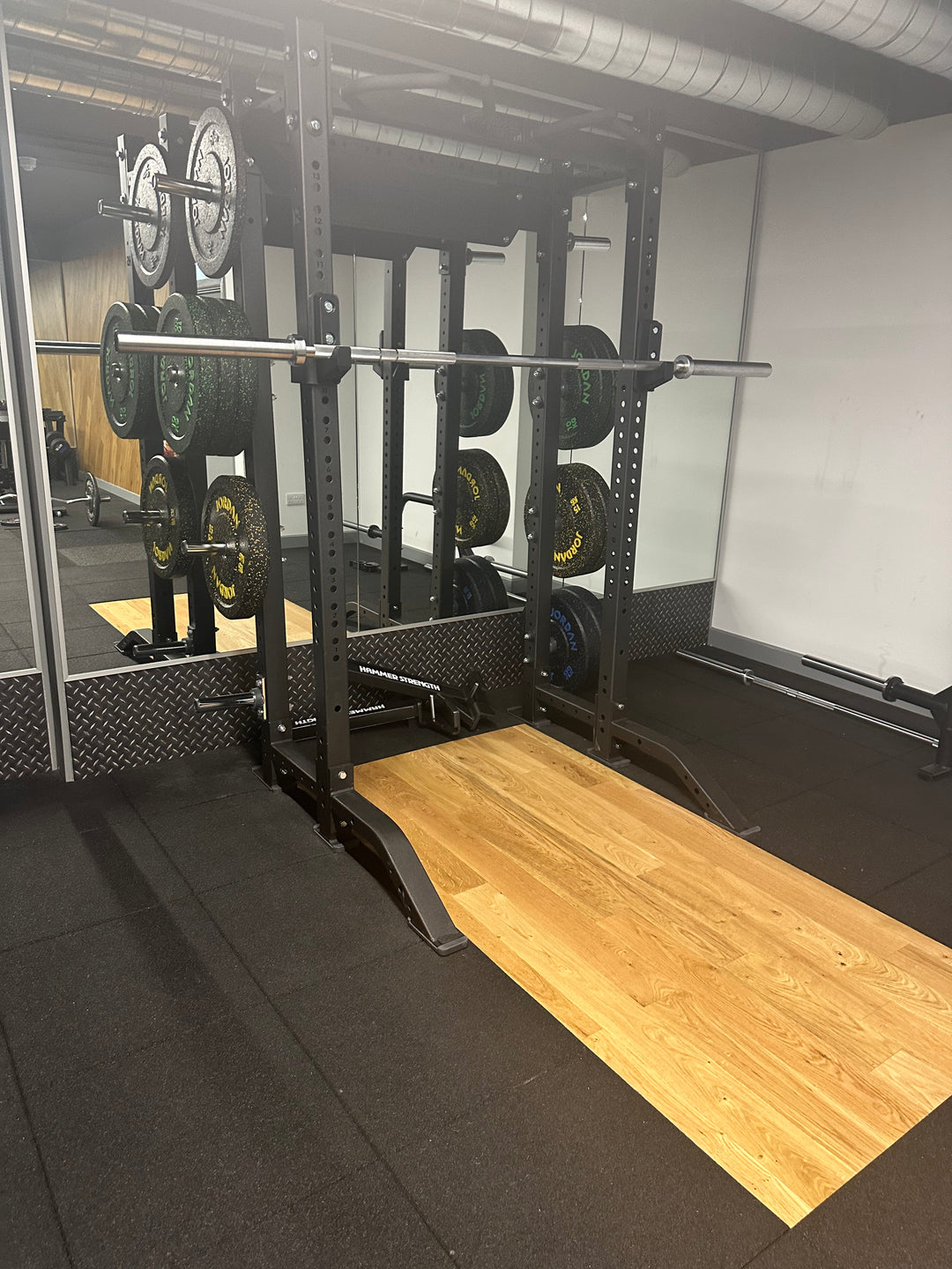 SilentTile 70mm Acoustic Gym Flooring Fitness Interlocking Tile/System, displayed in a gym setting beneath a power rack, exemplifies superior soundproofing and noise reduction, ideal for acoustic-sensitive environments.
