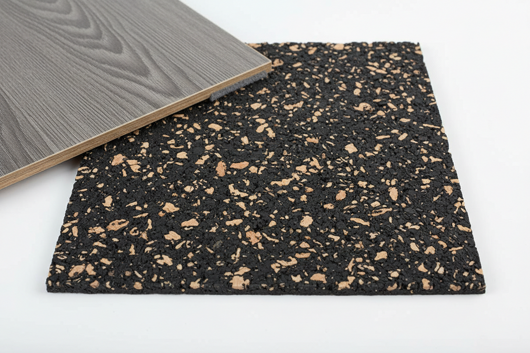 SilentCloud Acoustic Cork Rubber Underlay sample with gray wood-grain laminate plank atop. Premium soundproofing, noise reduction, and sound insulation for various floors. Ideal for residential and commercial use, available in 3mm and 4.5mm thicknesses.